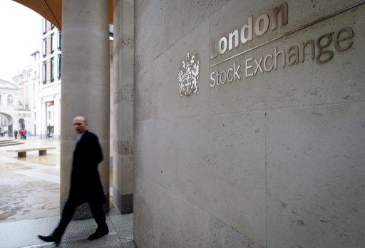 A man walks past the London Stock Exchange in central London on March 7, 2013. u00e2u20acu201d AFP pic