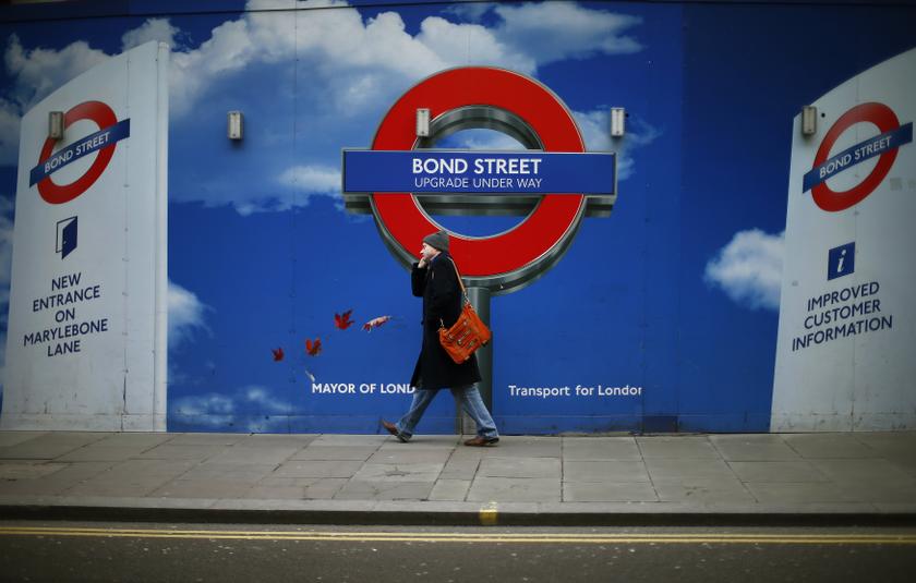 A man walks past hoardings surrounding the building work at London Underground's Bond Street station in central London January 27, 2014. u00e2u20acu201d Reuters pic
