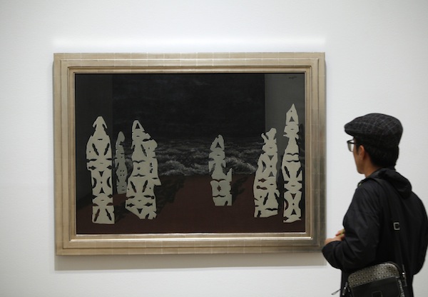 A visitor looks at the painting u00e2u20acu02dcThe Finery of the Stormu00e2u20acu2122 (1927) by artist Rene Magritte during the private opening of the exhibition u00e2u20acu02dcMagritte: The Mystery of the Ordinaryu00e2u20acu2122 in New York September 17, 2013. u00e2u20acu201d Reuters pic