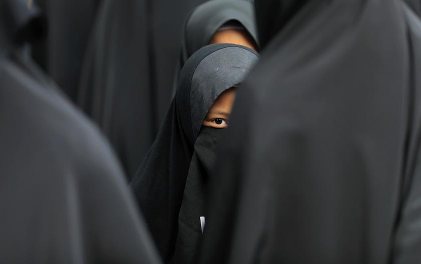 A girl wearing a hijab waits at the Shah Alam stadium during celebrations of Maulidur Rasul, or the birth of Prophet Muhammad, outside Kuala Lumpur January 14, 2014.u00c2u00a0u00e2u20acu201d Reuters pic