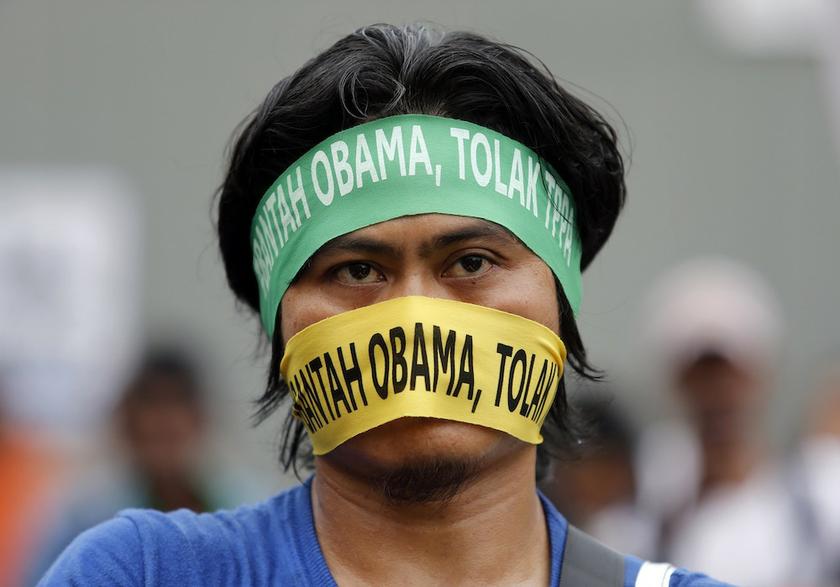 A protester wears headbands during a demonstration to pressure Malaysia against signing the Anti-Trans-Pacific Partnership Agreement (TPPA), outside the venue where US Secretary of State John Kerry delivered his speeches, in Kuala Lumpur October 11, 2013.