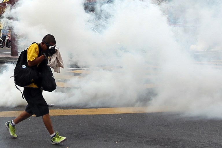 A protestor cover his face from the effects of tear gas fired by riot police during a mass rally organised by Bersih 3.0 calling for electoral reform in Kuala Lumpur on April 28, 2012. u00e2u20acu201d AFP pic