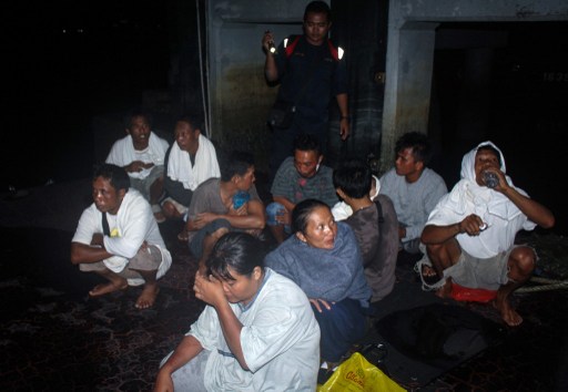 A handout photo taken on July 18, 2013 and released by the Malaysian Maritime Enforcement Agency shows passengers who were rescued from an overturned boat at a Jetty in Tanjung Sedili, Johor. u00e2u20acu201d AFP pic