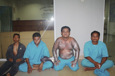 Survivors of a capsized boat are seen sitting at the maritime office in Tanjung Sedili, in Johor in this handout picture taken on August 2, 2013 and released to Reuters by Malaysian Maritime Enforcement Agency on August 3, 2013. u00e2u20acu201d Reuters pic