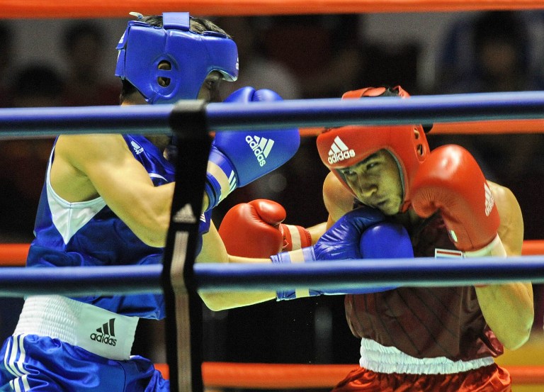 Mohd Subrie (L) of Malaysia competes against Chatchai Butdee (R) in the men's flyweight 52 kilogram boxing category at the 26th Southeast Asian Games (SEAGAMES) in Palembang, Sumatra province on November 17, 2011. u00e2u20acu201c AFP pic