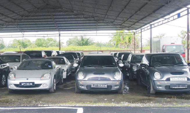 The cars that were seized for not paying taxes. u00e2u20acu201d Picture by Zuraneeza Zullkifli