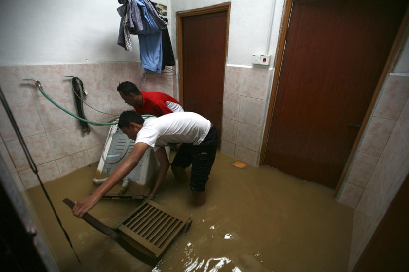 Residents lift up their washing machine in a house at Chenor, between the border state of Pahang and Terengganu, 300km outside Kuala Lumpur December 6, 2013. u00e2u20acu201d Reuters pic