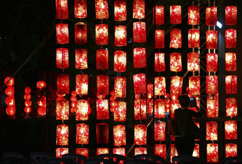 A woman takes a photo of Chinese lanterns ahead of Chinese New Year celebrations inside a temple in Jenjarom, outside Kuala Lumpur January 29, 2014. u00e2u20acu201d Reuters pic