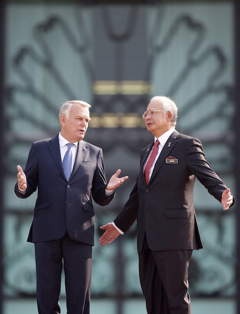 Visiting French Prime Minister Jean-Marc Ayrault and Prime Minister Najib Razak talk during a photo call after the state welcoming ceremony in Putrajaya July 29, 2013. u00e2u20acu201d Reuters pic