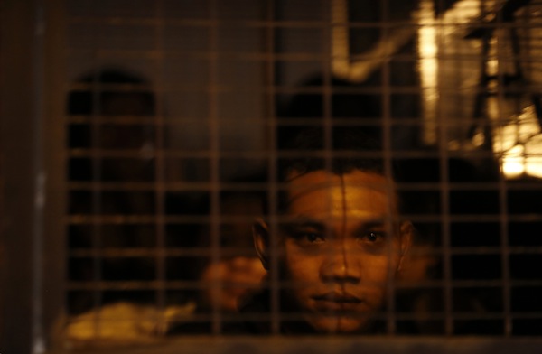 A detained suspected illegal migrant worker from Indonesia sits in an immigration truck during a crackdown on illegal migrant workers in Klang, outside Kuala Lumpur September 1, 2013. u00e2u20acu201d Reuters pic