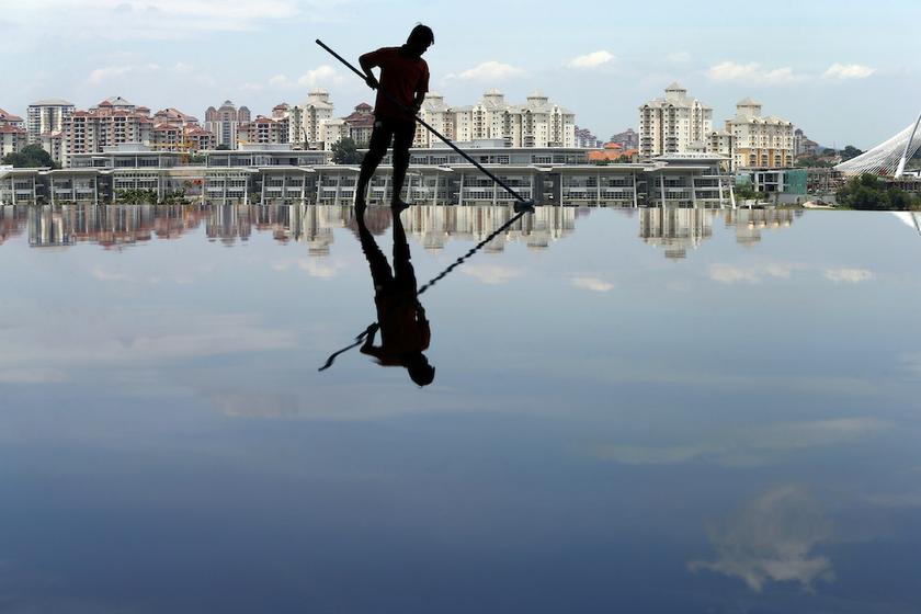 A worker cleans up a pool inside the Tuanku Mizan Zainal Abidin mosque in Putrajaya October 9, 2013. u00e2u20acu201d Reuters pic