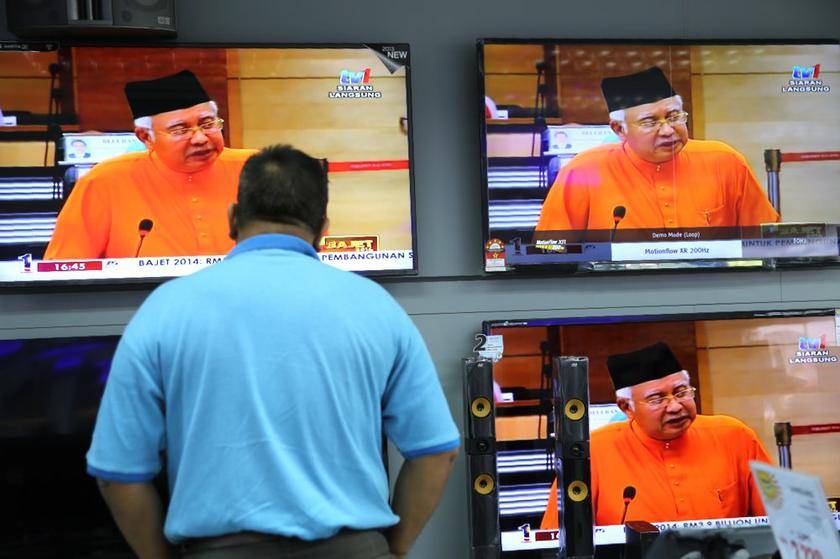 A man watches a live television broadcast of Prime Minister Datuk Seri Najib Razak tabling Budget 2014 in Parliament in Kuala Lumpur October 25, 2013. u00e2u20acu201d Picture by Choo Choy May