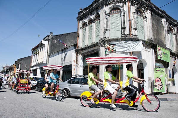 Tourists are seen riding rented tandem bicycles with canopies around George Townu00e2u20acu2122s heritage area on September 1, 2013. u00e2u20acu201d Picture by K.E. Ooi