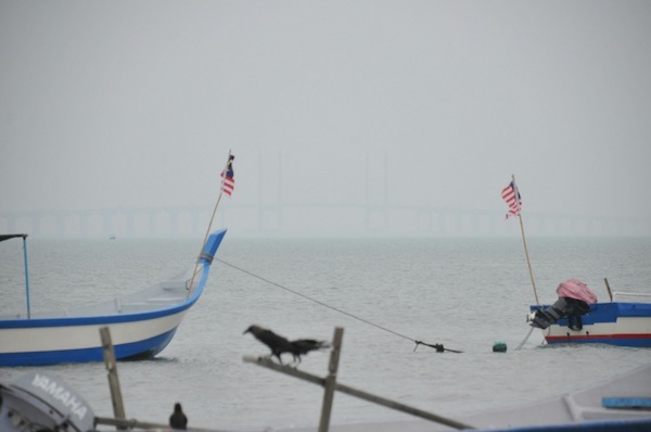 The Penang Bridge is barely visible at 2pm on August 28, 2013, as the API reached 100 in Seberang Jaya and 97 for Penang island. u00e2u20acu201d Picture by K.E. Ooi