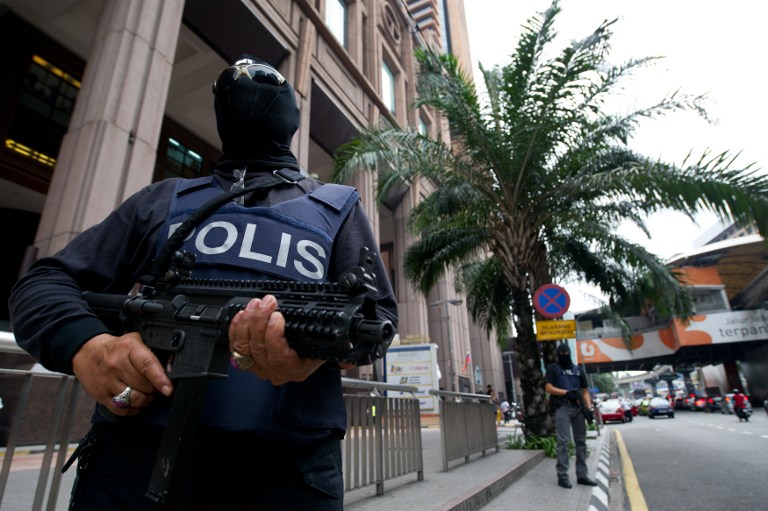 This picture taken on September 19, 2013 shows Malaysian special policemen standing during a press conference called u00e2u20acu02dcOp Cantas Khasu00e2u20acu2122 outside a shopping mall in downtown Kuala Lumpur. u00e2u20acu201d AFP pic