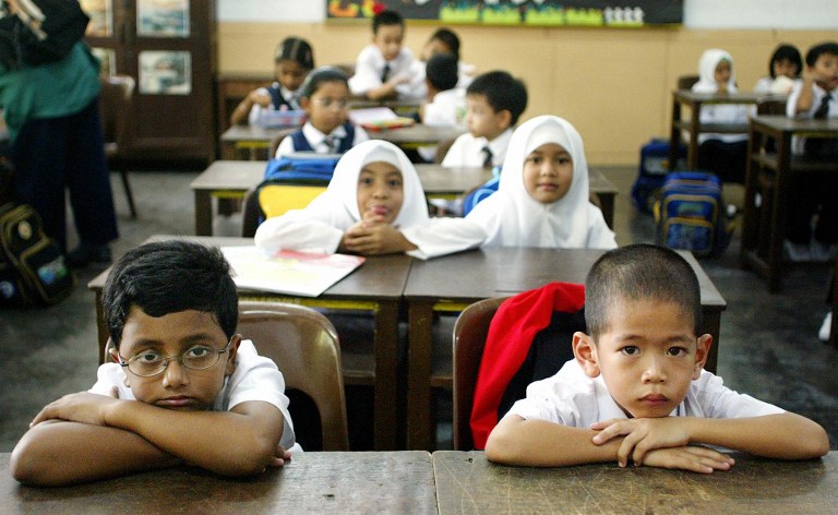 Children attend their first day of elementary school in Standard One (Primary One) at a local school on the start of the new school year in Kuala Lumpur on 6 January 2003. u00e2u20acu201d AFP pic