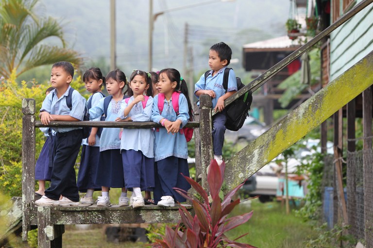 This picture taken on September 22, 2011 shows students waiting at their long house for transport to school in Sungai Asap, Sarawak. u00e2u20acu201d AFP pic