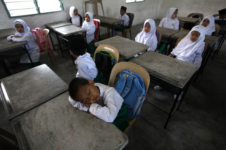 A student sleeps inside a classroom during the first day of school at an islamic local school in Kuala Lumpur on January 4, 2012. u00e2u20acu201d AFP pic