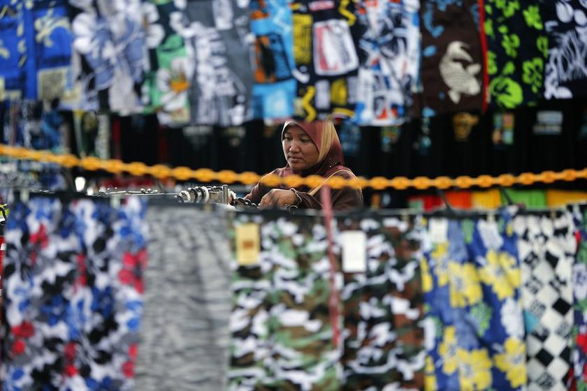 A vendor hangs clothes to sell near Cherating beach, outside Kuala Lumpur November 15, 2013. u00e2u20acu201d Reuters pic