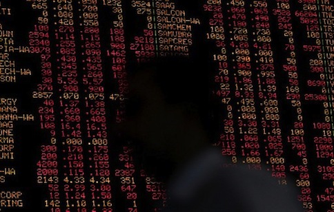 A Malaysian trader walks past a digital share price board showing the Malaysian Index in Kuala Lumpur on August 8, 2011. u00e2u20acu201d AFP pic