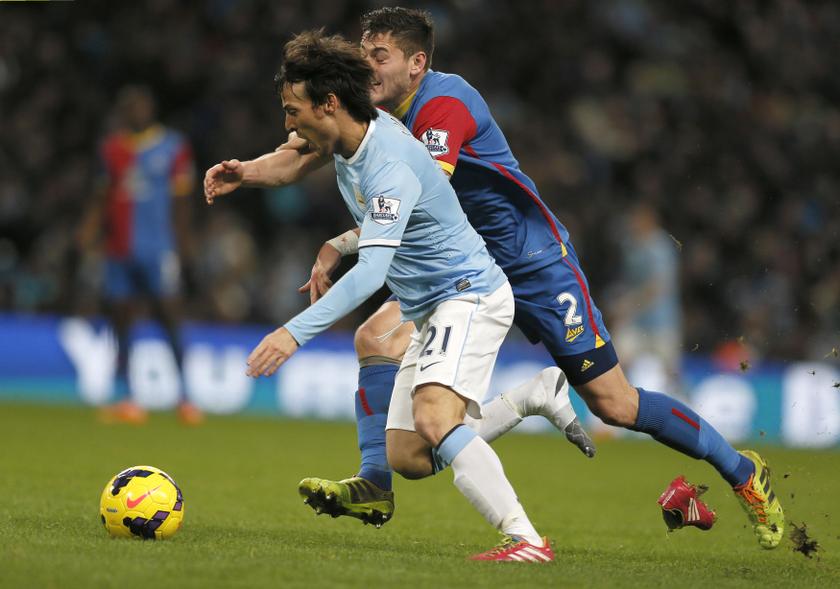 Manchester City's David Silva (left) looses his boot as he is challenged by Crystal Palaceu00e2u20acu2122s Joel Ward during their English Premier League soccer match at the Etihad stadium in Manchester, northern England, December 28, 2013. u00e2u20acu201d Reuters pic
