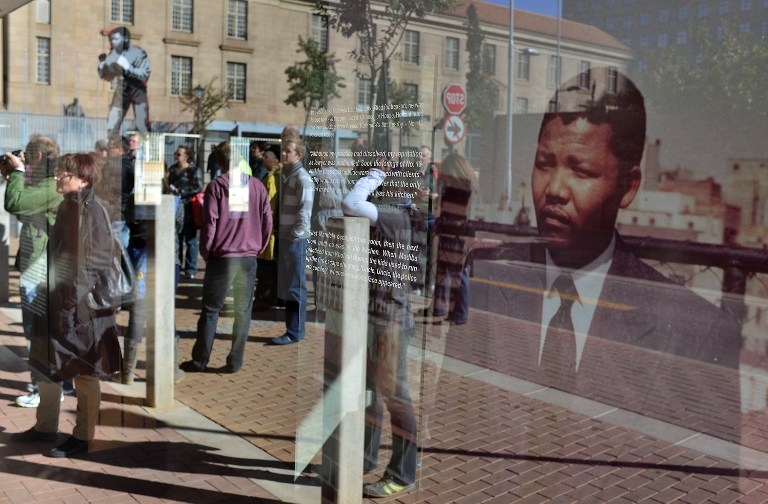 Tourists on u00e2u20acu0153the Mandela walku00e2u20acu009d look on June 15, 2013 at an outside exhibition at Chancellor House in Pretoria. u00e2u20acu201d AFP pic