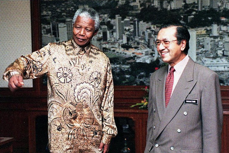 In this file picture, South African President Nelson Mandela chats with Tun Mahathir Mohamad before the start of their talks in Kuala Lumpur 07 March, 1997. u00e2u20acu201d AFP pic