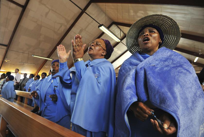 Women reflect and say a prayer for the late former South African President Nelson Mandela at the Regina Mundi Church in Soweto December 8, 2013. South African anti-apartheid hero Mandela died aged 95 at his Johannesburg home on December 5 after a prolonge