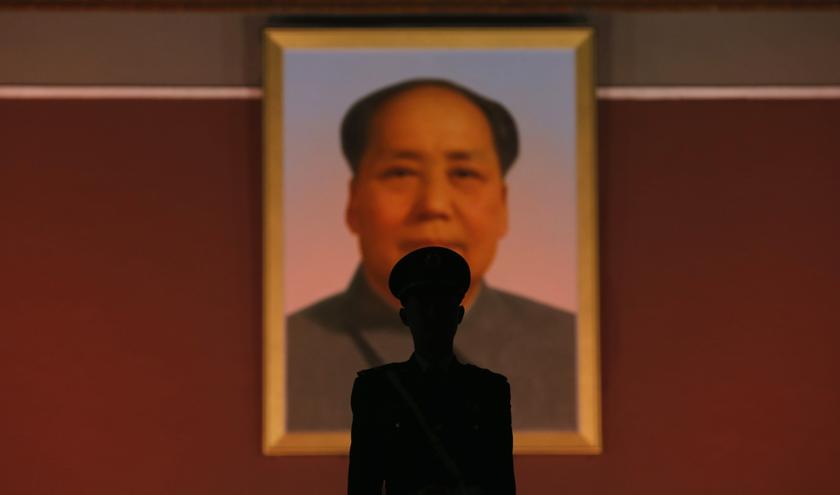 A paramilitary policeman stands guard in front of the giant portrait of Chairman Mao Zedong at the main entrance of the Forbidden City in Beijing October 28, 2013. u00e2u20acu201d Reuters pic