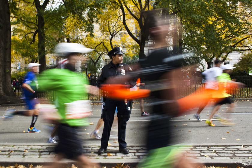 An NYPD officer stands guard while runners make their way through the borough of Manhattan during the New York City Marathon in New York, November 3, 2013. u00e2u20acu201d Reuters pic
