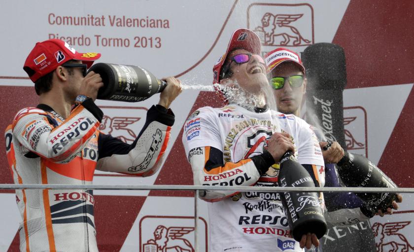 Marc Marquez (centre) is sprayed on podium by Dani Pedrosa (left) and Jorge Lorenzo after becoming the youngest MotoGP world champion at the end of the Valencia Motorcycle Grand Prix, near Valencia, November 10, 2013. u00e2u20acu201d Reuters pic