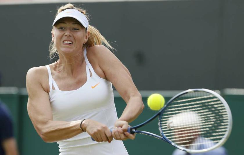 Maria Sharapova of Russia hits a return to Michelle Larcher De Brito of Portugal during their womenu00e2u20acu2122s singles tennis match at the Wimbledon Tennis Championships, in London on June 26, 2013. u00e2u20acu201d Reuters pic