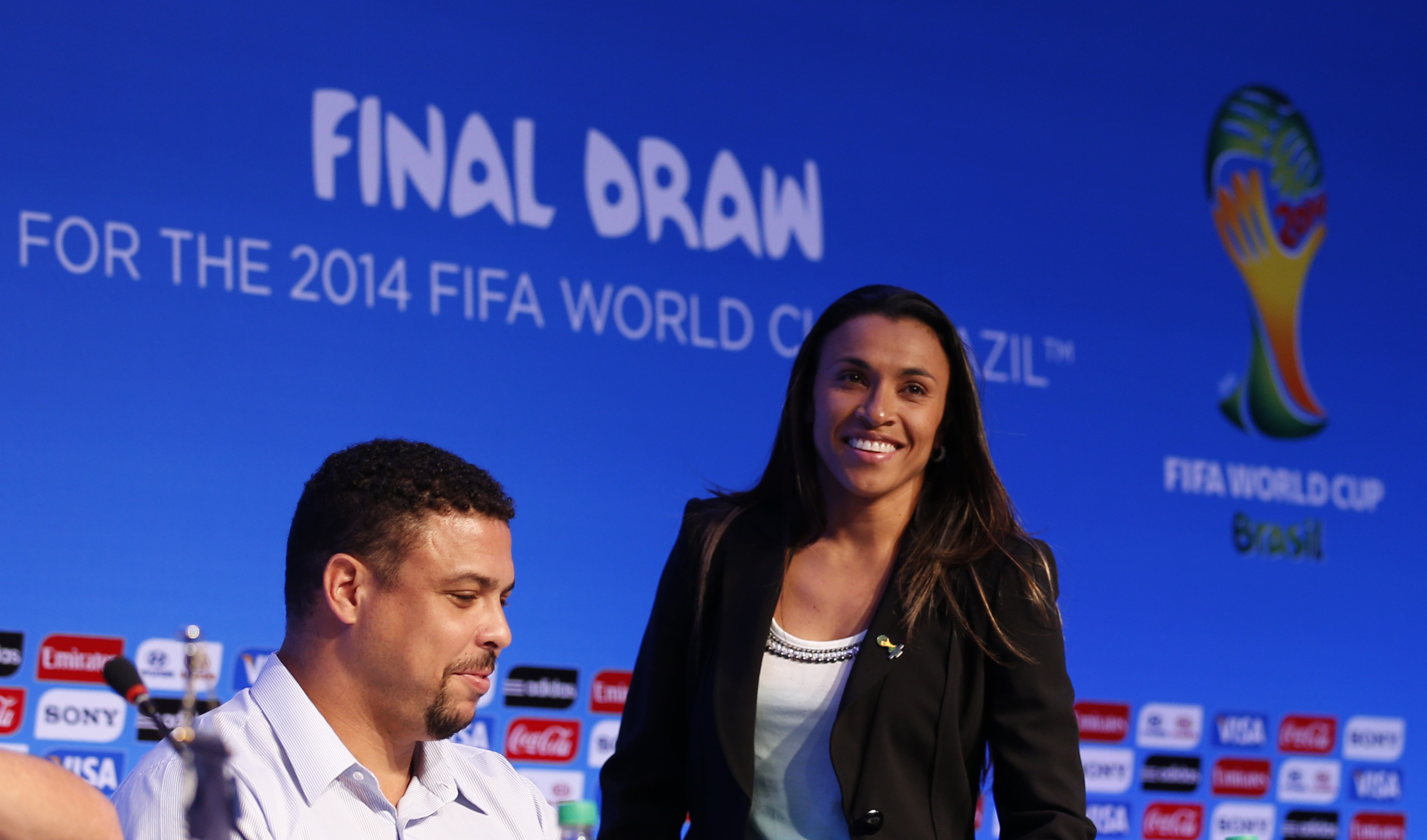 Five-time FIFA world women's football player of the year Marta Vieira da Silva (right) of Brazil arrives to a news conference with former Brazilian football player Ronaldo ahead to the draw for the 2014 World Cup in Sao Joao da Mata, December 5, 2013. u00e2u20acu201d