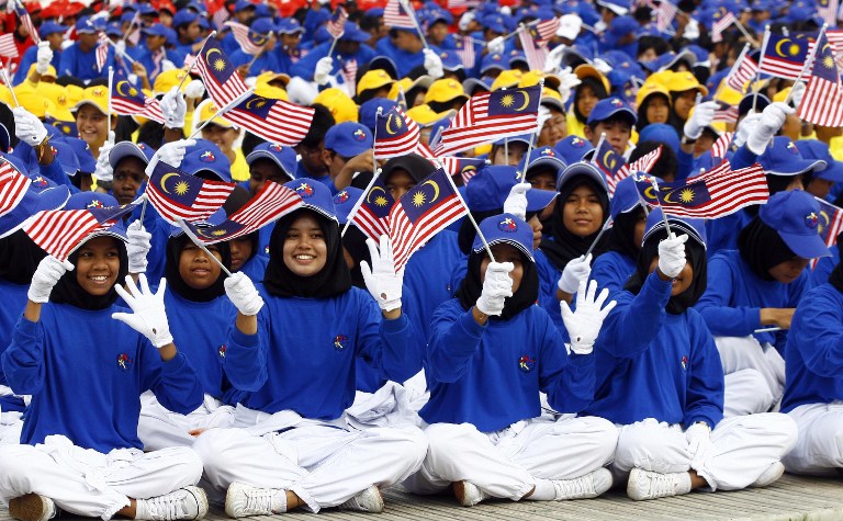 Parade participants wave Malaysian flags during Malaysia's 51st Independence Day parade at the historical Merdeka Square in downtown Kuala Lumpur on August 31, 2008. u00e2u20acu201c AFP pic