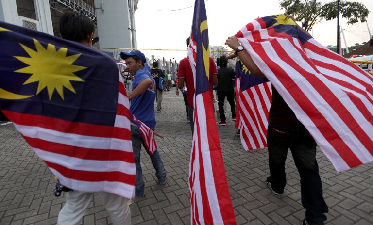 Malaysian hold national flags during a rally to celebrate the country's 55th Independence Day in Bukit Jalil Stadium, some 20 kilometres south of Kuala Lumpur on August 31, 2012. u00e2u20acu201c AFP pic