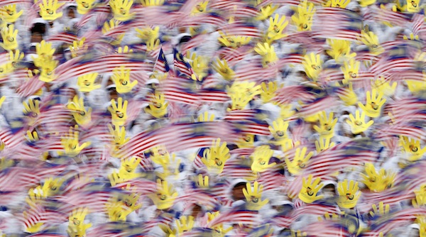 Malaysian youths wave national flags during National Day celebrations marking the 56th anniversary of the countryu00e2u20acu2122s independence in Kuala Lumpur August 31, 2013. u00e2u20acu201d Reuters pic