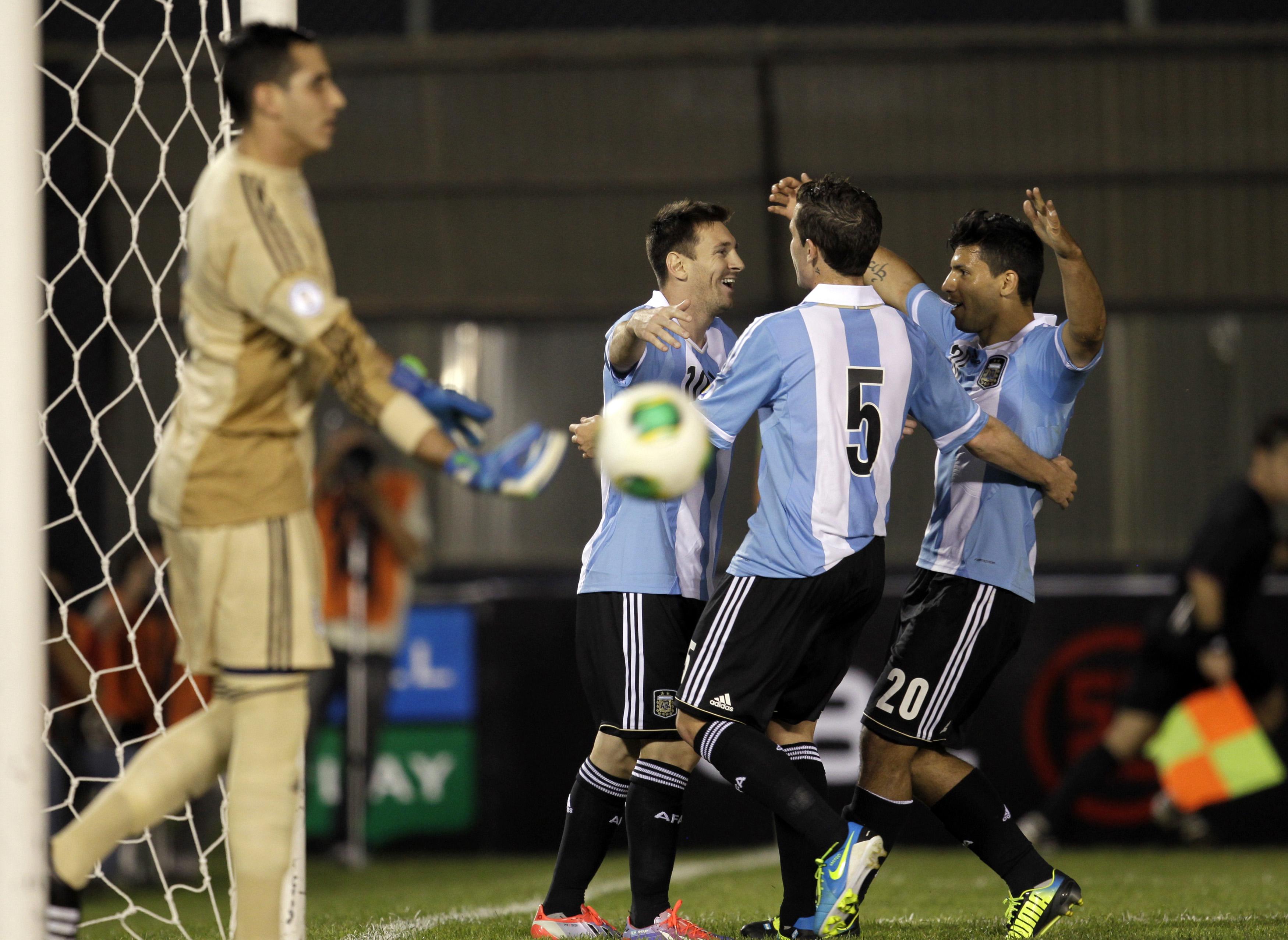 Argentina's Lionel Messi (second left) celebrates a goal with teammates Sergio Aguero (right) and Fernando Gago during their 2014 World Cup qualifying match in Asuncion, Sept 10, 2013. u00e2u20acu201d Reuters pic