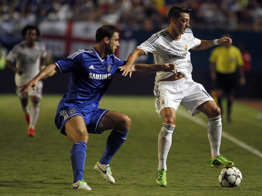 Chelsea's Branislav Ivanovic (left) and Real Madrid's Mesut Ozil fight for the ball during their Guinness International Champions Cup final match in Miami Gardens, Florida August 7, 2013. u00e2u20acu201c Reuters pic
