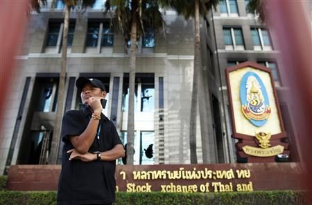 A security guard secures the building of Stock Exchange of Thailand that was partially burnt during recent clashes in Bangkok May 24, 2010