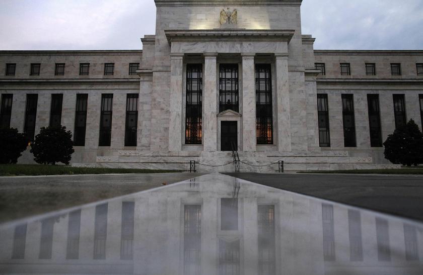 The U.S. Federal Reserve building is reflected on wet marble during the early morning hours in Washington, July 31, 2013 Reuters pic