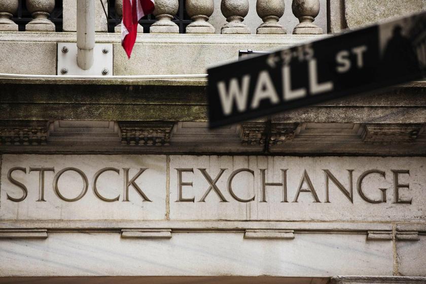 A street sign for Wall Street hangs in front of the New York Stock Exchange May 8, 2013