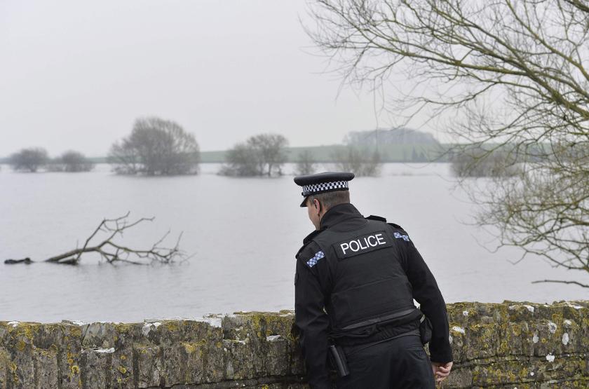 A police officer inspects flooded areas near the village of Muchelney on the Somerset Levels, near Langport in south west England January 30, 2014. u00e2u20acu201d Reuters pic