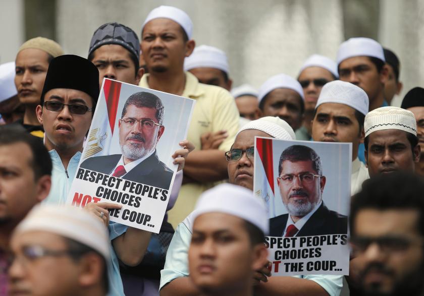 Supporters of Egypt's deposed Islamist President Mohamed Mursi and the Muslim Brotherhood display placards during a demonstration in protest of the recent violence in Egypt, in Shah Alam August 16, 2013. u00e2u20acu201c Reuters pic