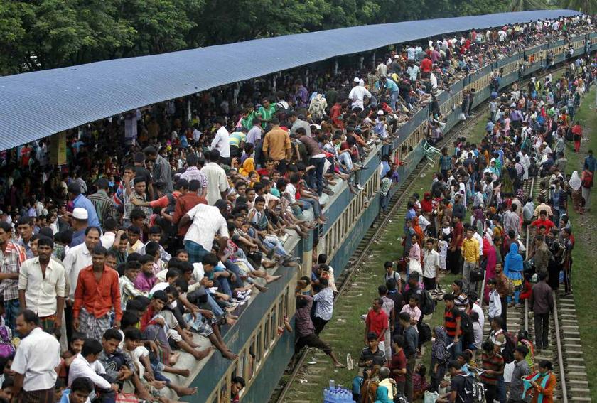 Passengers climb to board an overcrowded train at a railway station in Dhaka on August 8, 2013 as they travel home from the capital city to celebrate the Muslim Eid al-Fitr holiday. u00e2u20acu201d Reuters pic
