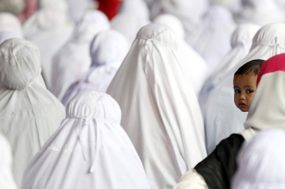 Alya Ilhami Ahmad Iran, 17 months, looks on as she joins her family to perform Eid al-Fitr prayers at a mosque in Kota Baru on August 8, 2013. u00e2u20acu201d Reuters pic