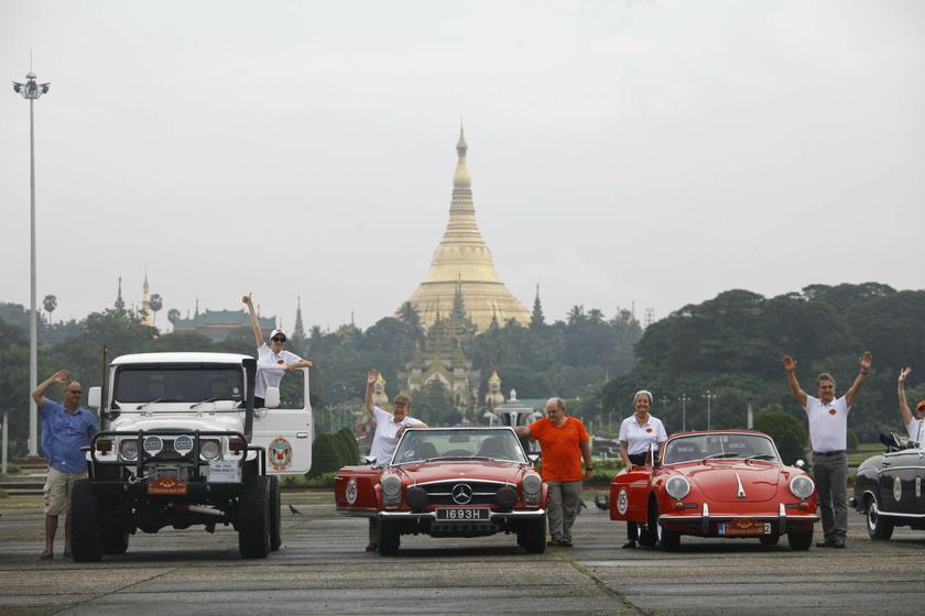 Classic cars line up for a photo with Shwedagon Pagoda in the background, during the start of 'The Burma Road Classic' motoring rally in Yangon October 28, 2013. u00e2u20acu201d Reuters pic