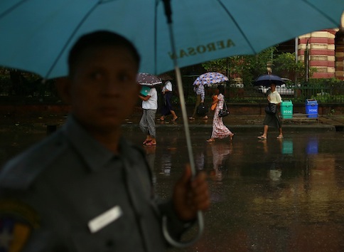 People use umbrellas as rain falls in Yangon August 1, 2013. u00e2u20acu201d Reuters pic
