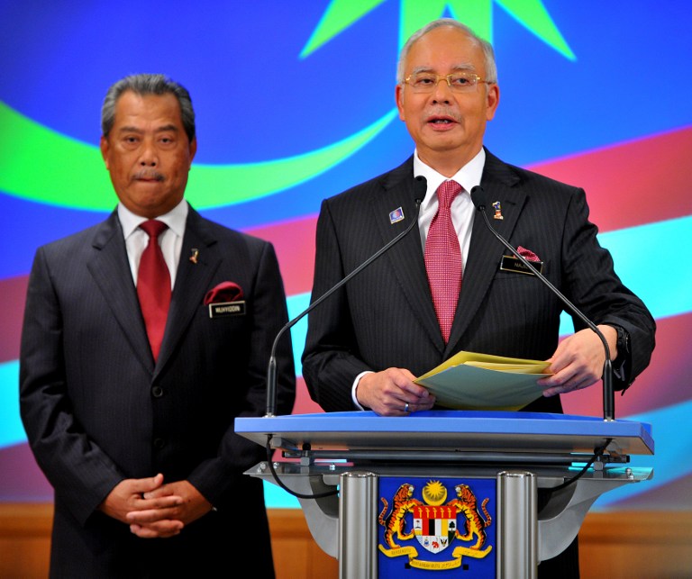 Malaysia's Prime Minister Najib Razak (R) gestures after announcing his cabinet line-up as his deputy Muhyiddin Yassin looks on in Putrajaya on May 15, 2013. - AFP pic