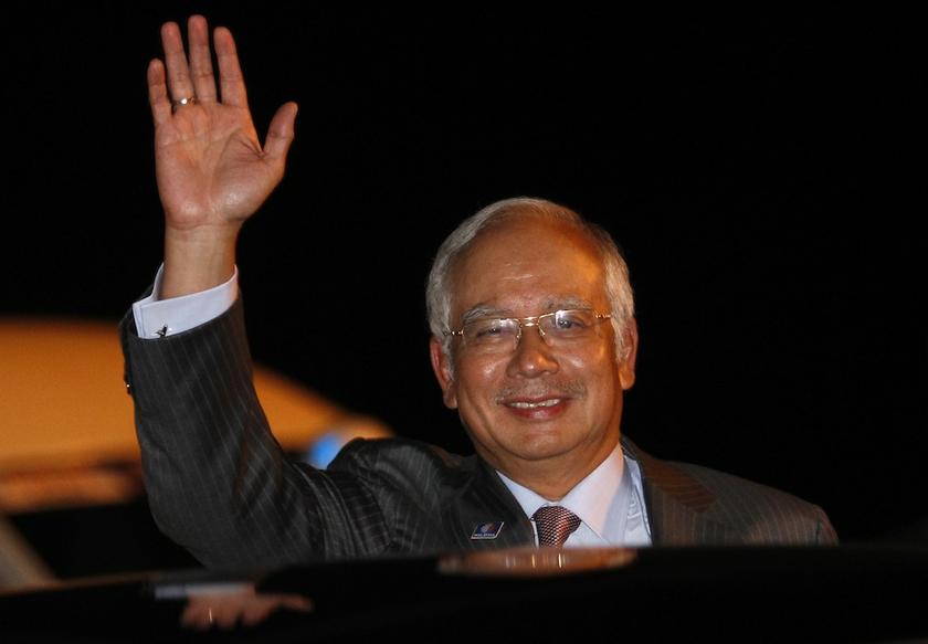 Prime Minister Datuk Seri Najib Razak waves as he arrives at Ngurai Rai airport in Denpasar, Bali, October 6, 2013, to attend the Asia-Pacific Economic Cooperation (APEC) Summit. u00e2u20acu201d Reuters pic