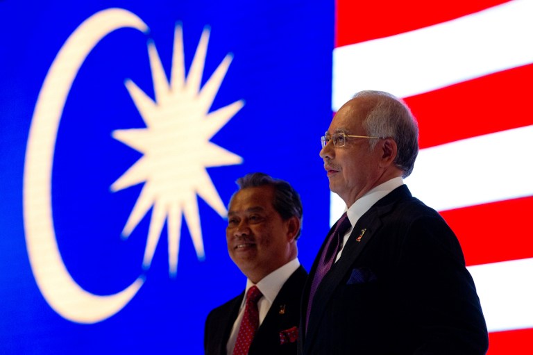 Malaysian Prime Minister Najib Razak (and his Deputy Muhyiddin Yassin stand onstage during a live telecast for the launch of the National Transformation Programme Annual Report in Kuala Lumpur on March 19, 2013. u00e2u20acu201c AFP pic